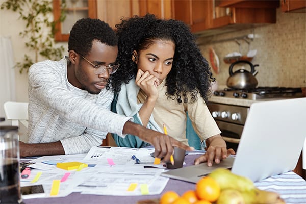 A couple looking for a home on the computer together