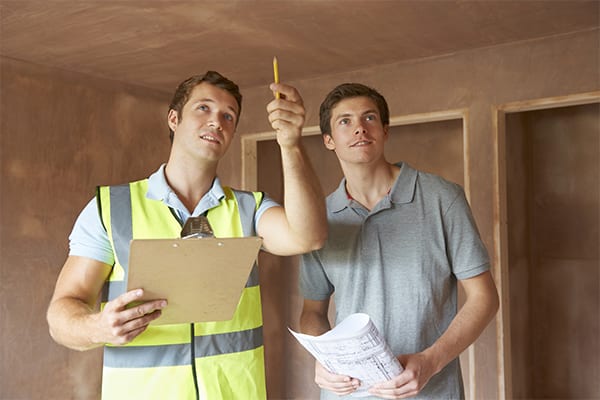 Home inspector going over findings with home owner
